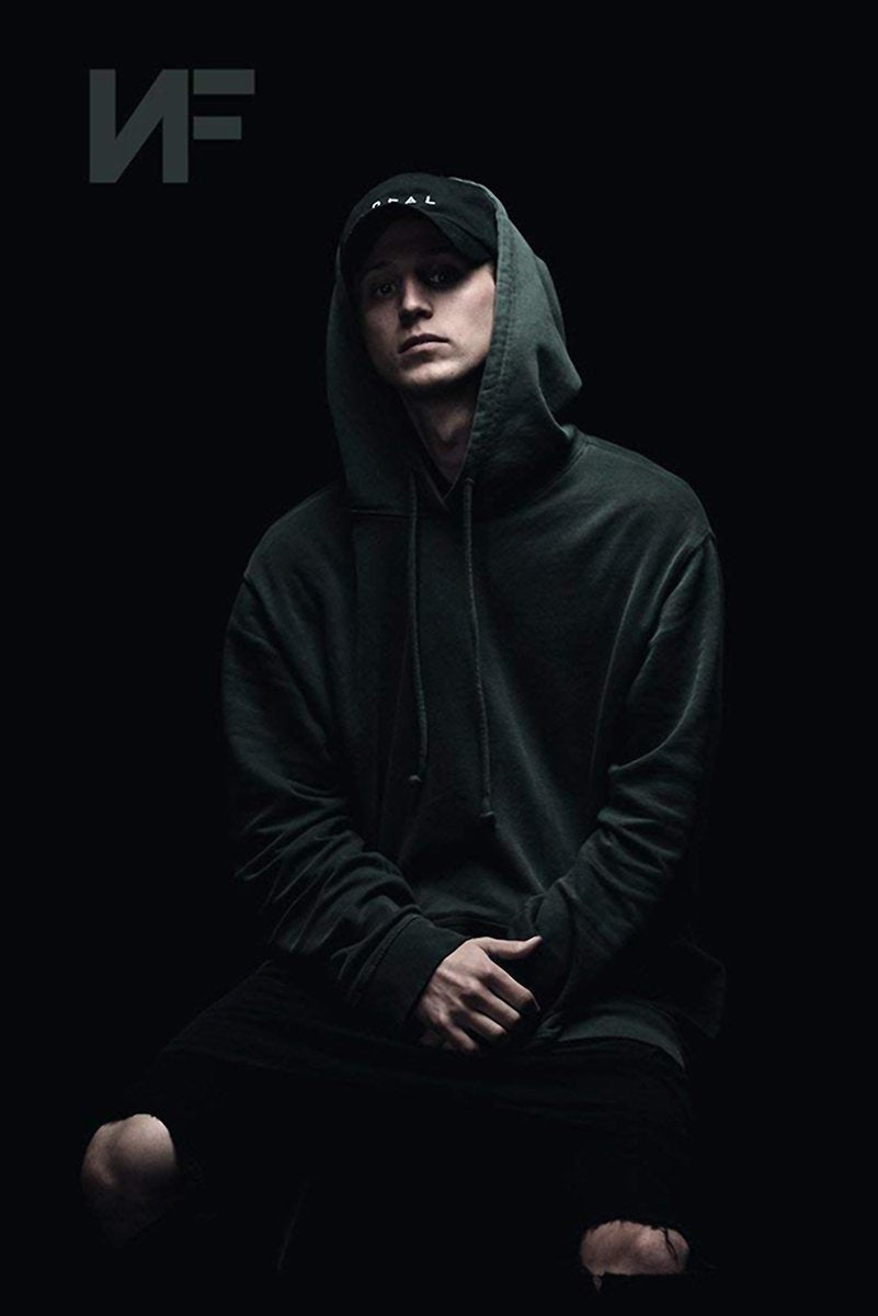 NF poster features a seated man in a dark hooded sweatshirt and cap against a black background, with the NF logo above.