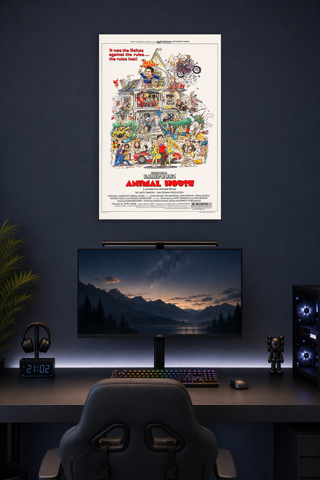 National Lampoon's Animal House Movie Poster in a gaming desk setup above a monitor.