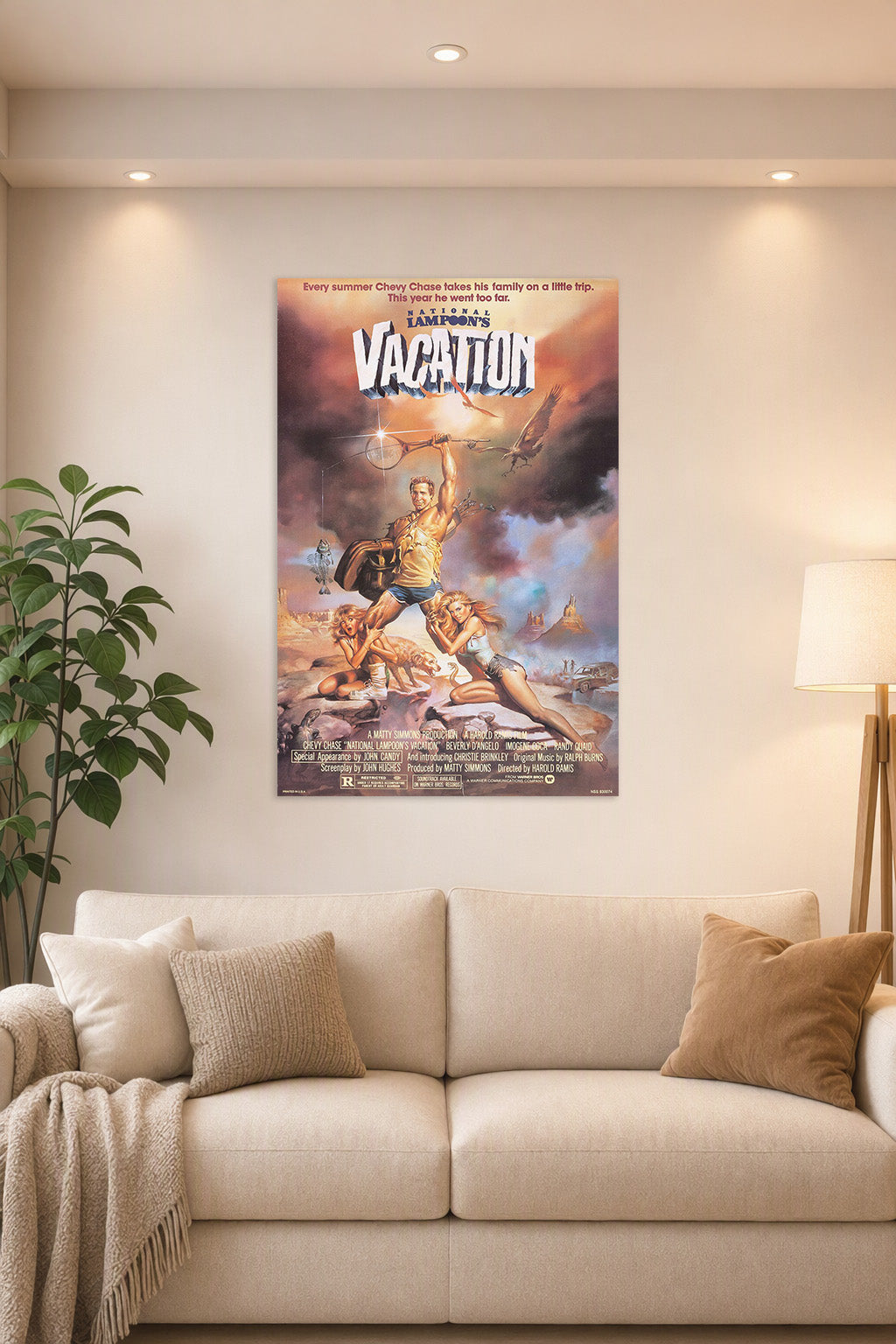National Lampoon's Vacation Movie Poster in a bright living room above a beige sofa.