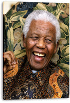 Nelson Mandela canvas wall art print displays his joyful portrait in a patterned black and orange shirt with visible wrapped edges.