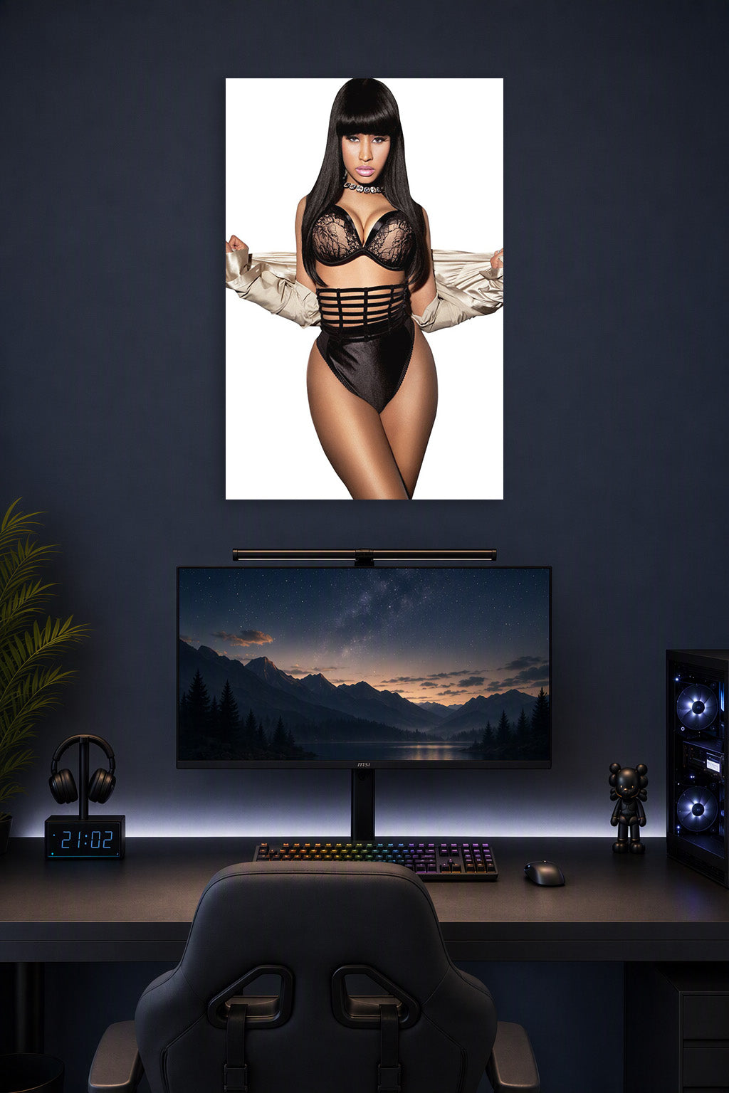 Nicki Minaj in a gaming desk setup above a monitor.