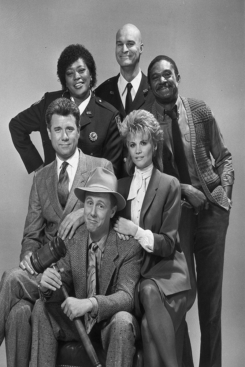 Night Court poster features a black-and-white cast portrait, with six smiling adults in courtroom-inspired attire and a seated man holding a gavel.