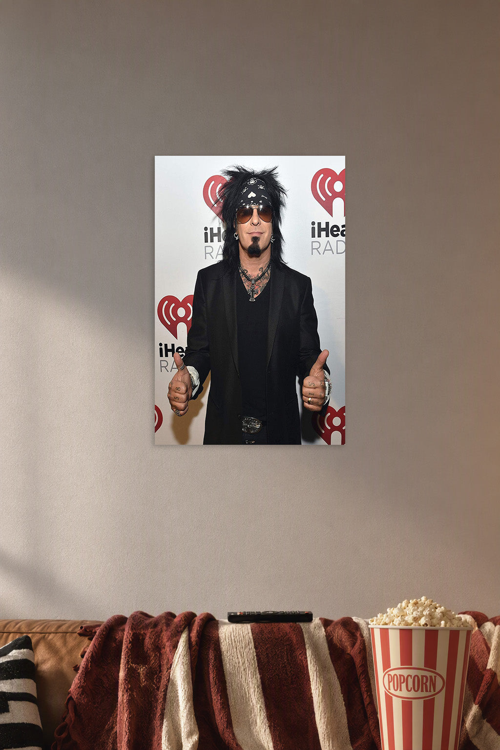 Nikki Sixx (Mötley Crüe) in a cozy movie room above a brown sofa with popcorn.