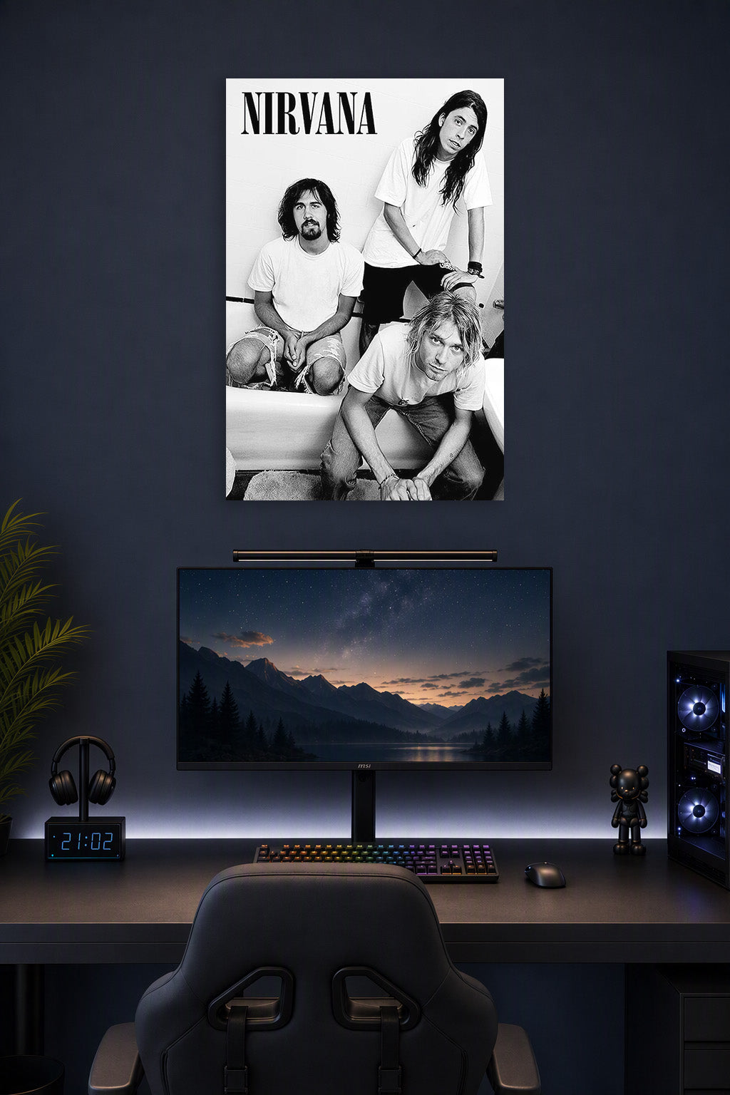 Nirvana (B&W - Kurt, Krist & Dave) Music in a gaming desk setup above a monitor.