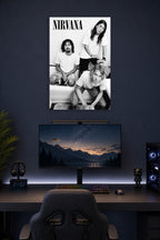 Nirvana (B&W - Kurt, Krist & Dave) Music in a gaming desk setup above a monitor.