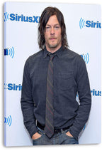 Norman Reedus canvas wall art print displays his hands-in-pockets portrait, with SiriusXM logos on a pale background.