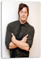 Norman Reedus canvas wall art print presents his crossed-arm portrait in a dark shirt and black tie on a white background.