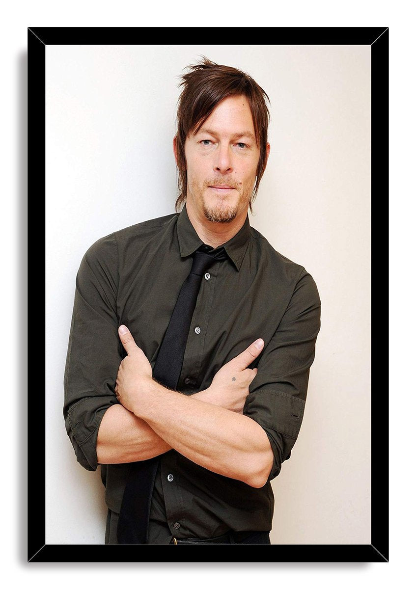 Norman Reedus framed wall art print displays a calm portrait with crossed arms, dark shirt, and black tie in a black frame.