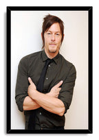Norman Reedus framed wall art print displays a calm portrait with crossed arms, dark shirt, and black tie in a black frame.