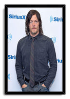 Norman Reedus framed wall art print presents a portrait in denim-blue clothing and tie, bordered by a black frame.