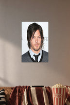 Norman Reedus in a cozy movie room above a brown sofa with popcorn.