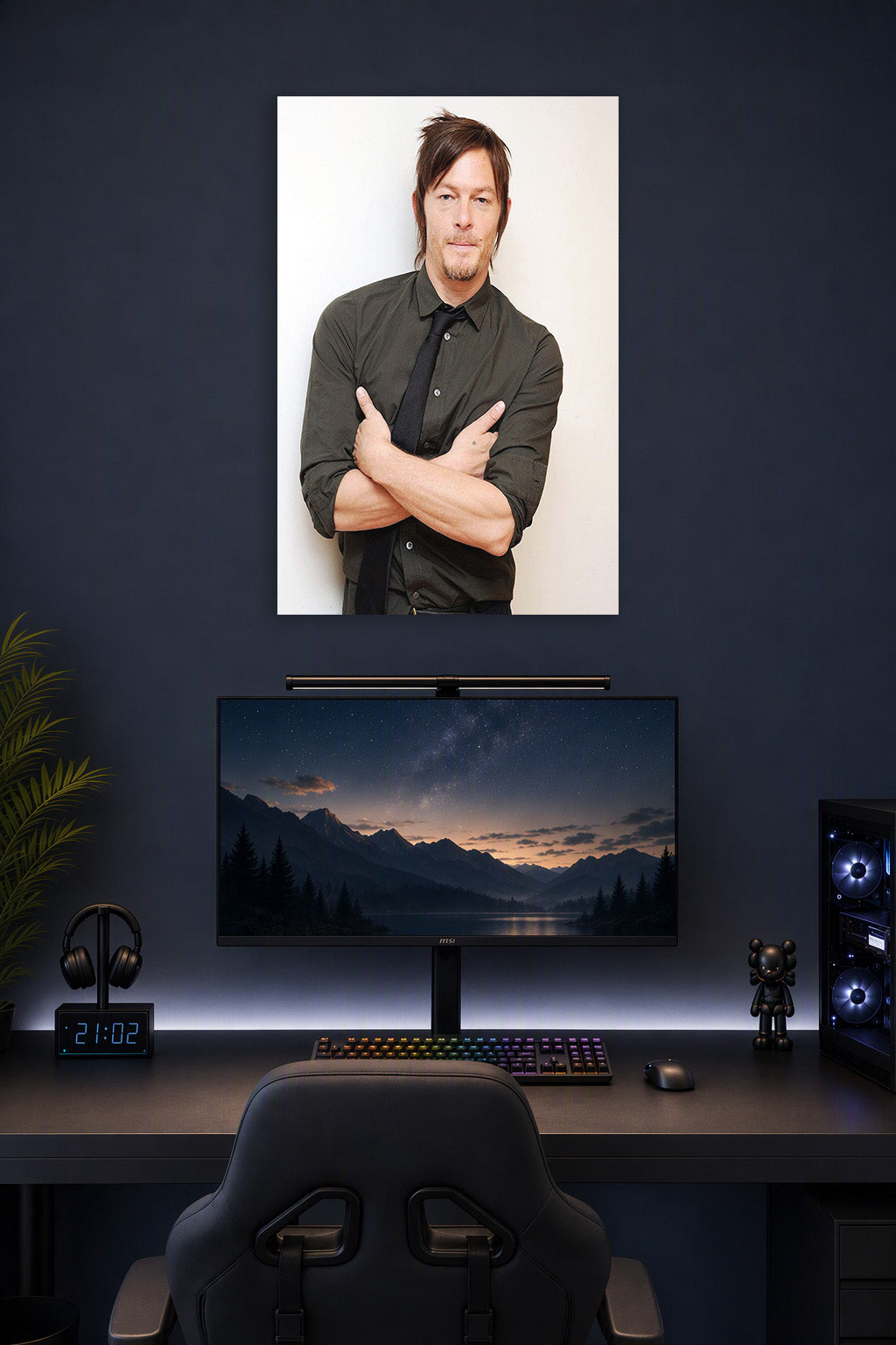 Norman Reedus in a gaming desk setup above a monitor.