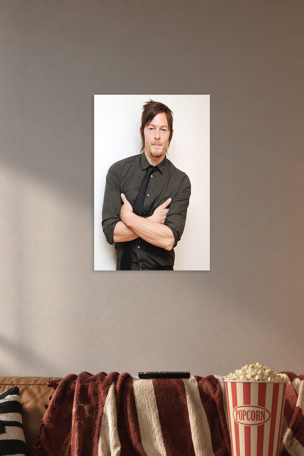 Norman Reedus in a cozy movie room above a brown sofa with popcorn.