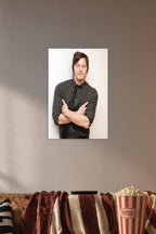 Norman Reedus in a cozy movie room above a brown sofa with popcorn.