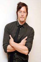 Norman Reedus wall art print features a front-facing portrait in a dark button-up shirt and black tie, arms crossed against white.