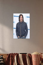 Norman Reedus in a cozy movie room above a brown sofa with popcorn.