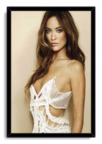 Olivia Wilde framed wall art print with a black border, portraying her in a white crochet dress against beige.