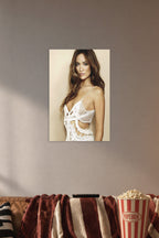Olivia Wilde in a cozy movie room above a brown sofa with popcorn.