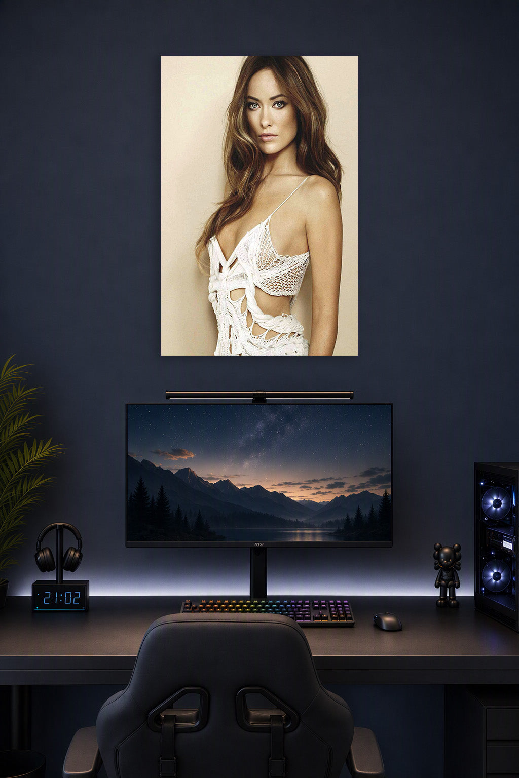 Olivia Wilde in a gaming desk setup above a monitor.
