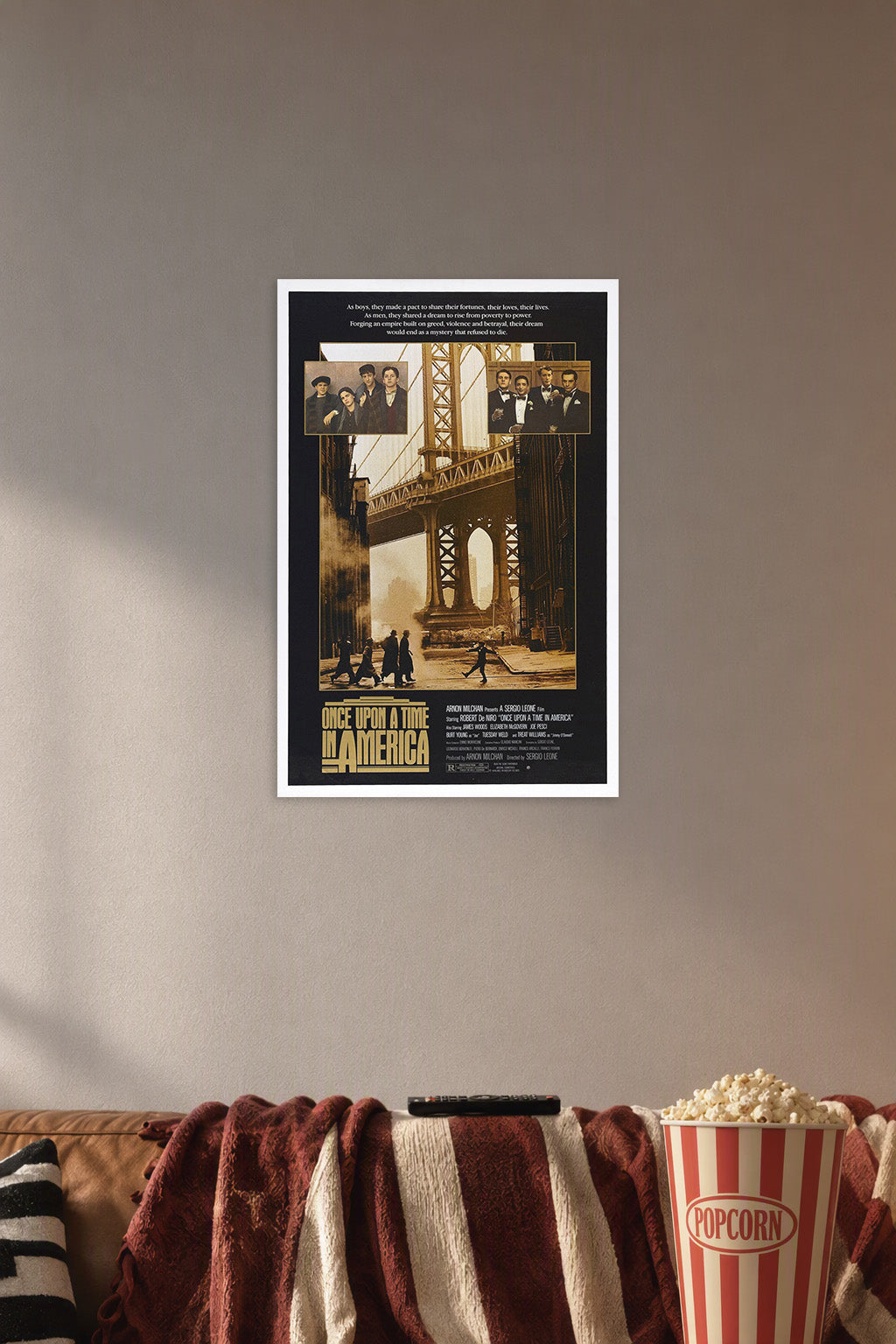 Once Upon a Time in America Movie Poster in a cozy movie room above a brown sofa with popcorn.