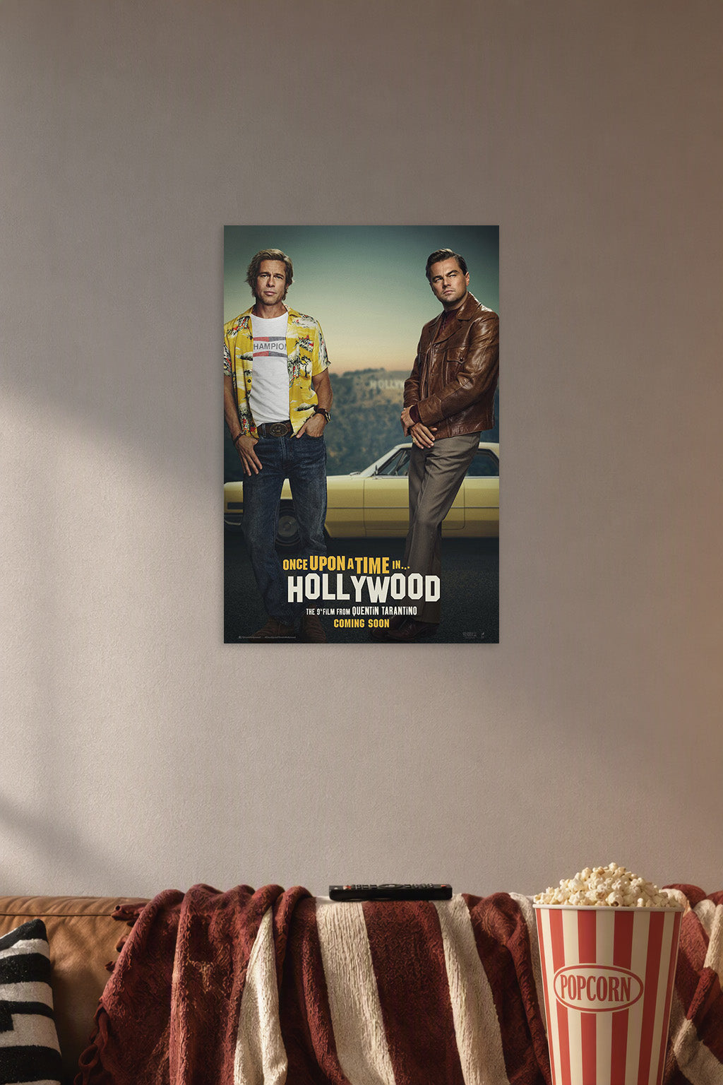 Once Upon a Time in Hollywood in a cozy movie room above a brown sofa with popcorn.