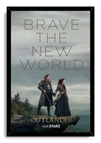 Framed Outlander wall art print portrays Jamie and Claire holding hands on a rugged overlook beneath a gray, misty sky.