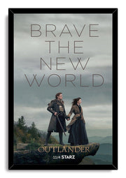 Framed Outlander wall art print portrays Jamie and Claire holding hands on a rugged overlook beneath a gray, misty sky.