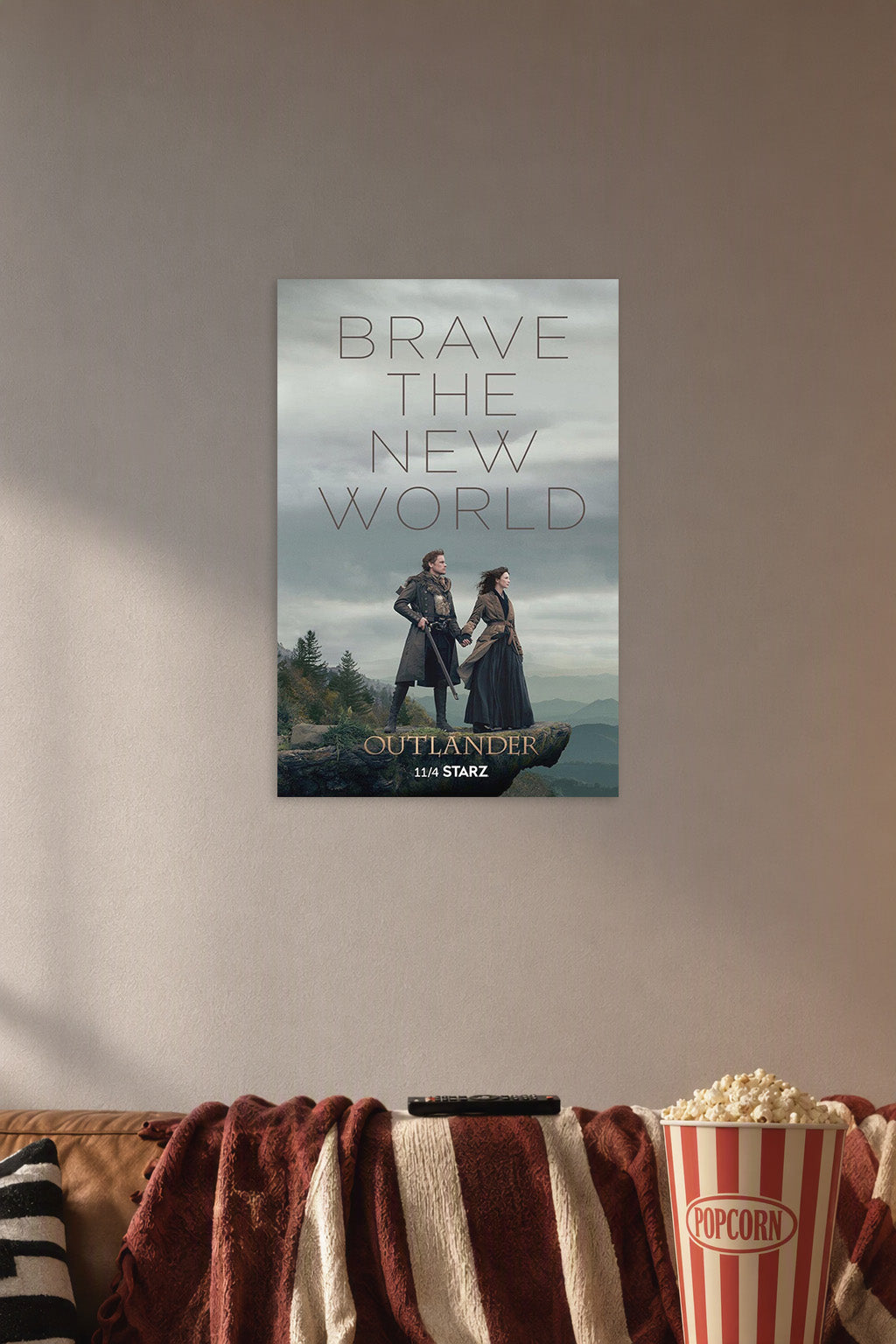 Outlander TV Series in a cozy movie room above a brown sofa with popcorn.