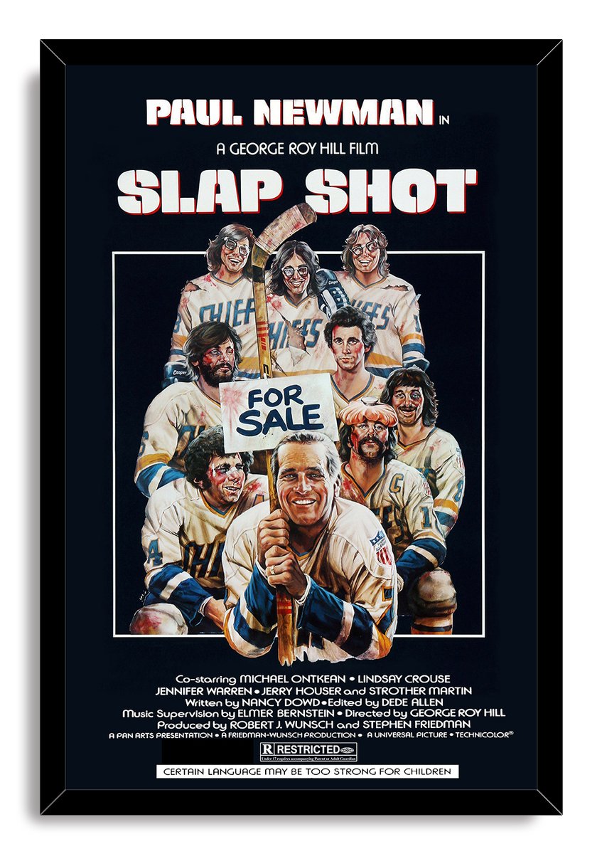 Slap Shot framed wall art print features Paul Newman gripping a hockey stick before his colorful, battered Chiefs teammates.