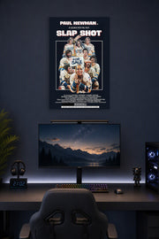 Paul Newman Slap Shot Movie in a gaming desk setup above a monitor.