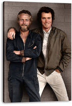 Paul Newman and Clint Eastwood canvas wall art print, a full-length portrait of the smiling actors against a gray brick wall.