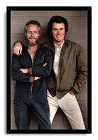 Paul Newman and Clint Eastwood framed wall art print, posing together in workwear and a green jacket against gray brickwork.