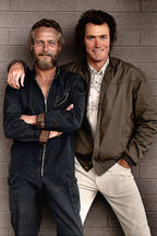 Paul Newman and Clint Eastwood wall art print, standing arm in arm before a gray brick wall in casual dark and olive clothing.