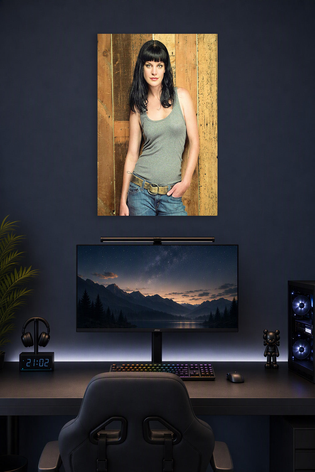 Pauley Perrette in a gaming desk setup above a monitor.