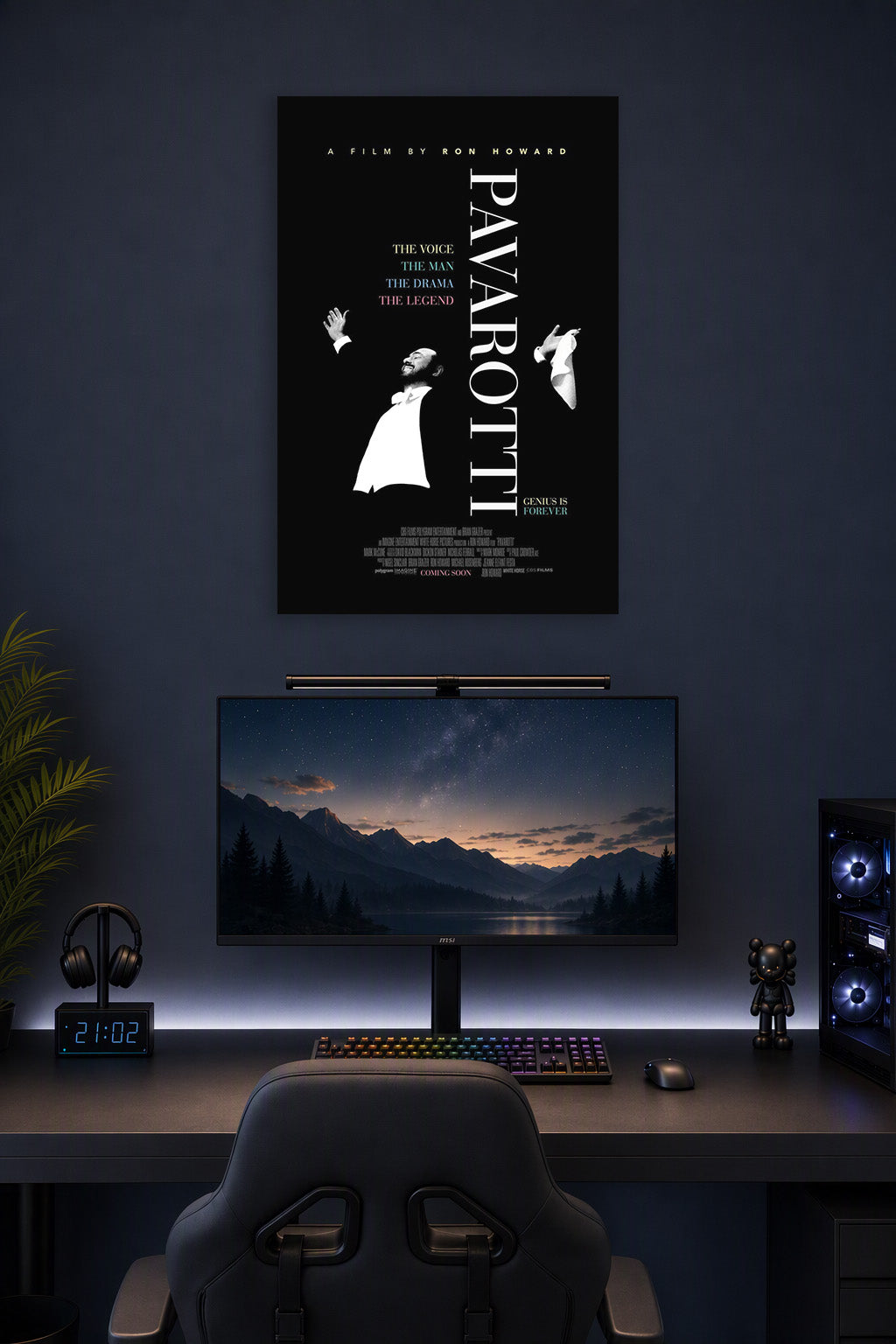 Pavarotti in a gaming desk setup above a monitor.