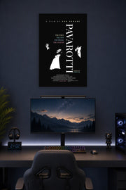 Pavarotti in a gaming desk setup above a monitor.