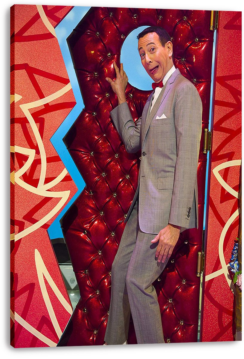 Pee-wee Herman canvas wall art print shows his playful pose in a gray suit against red geometric panels and blue trim.