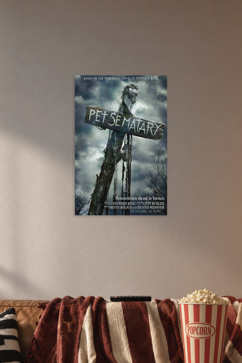 Pet Sematary Movie Poster in a cozy movie room above a brown sofa with popcorn.