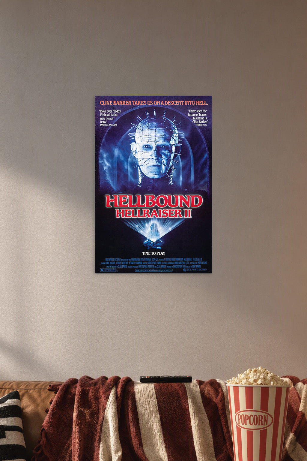 Pinhead Hellraiser II Horror Movie Poster in a cozy movie room above a brown sofa with popcorn.