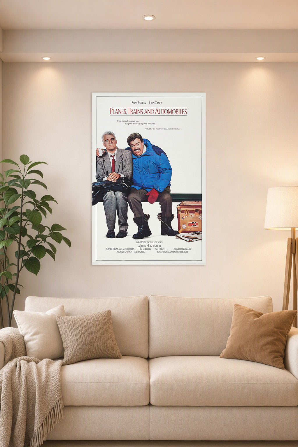 Planes, Trains & Automobiles Steve Martin John Candy in a bright living room above a beige sofa.
