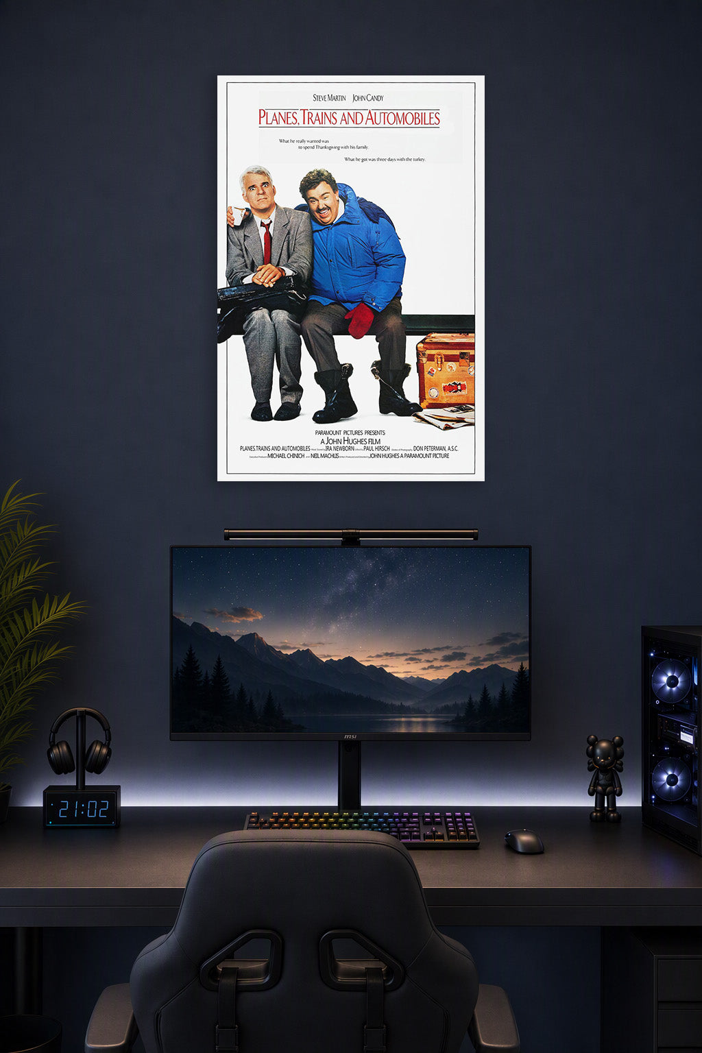 Planes, Trains & Automobiles Steve Martin John Candy in a gaming desk setup above a monitor.