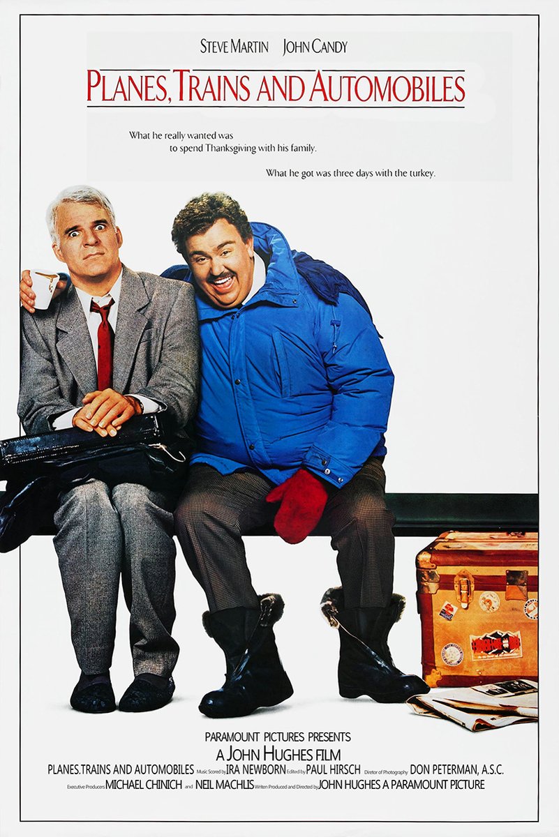 Planes, Trains and Automobiles poster with Steve Martin and John Candy seated beside a stickered suitcase.