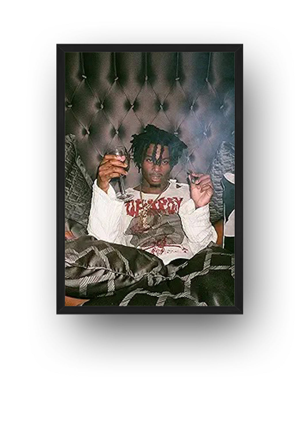 Playboi Carti framed wall art print featuring the rapper seated with a wine glass before a dark tufted background.
