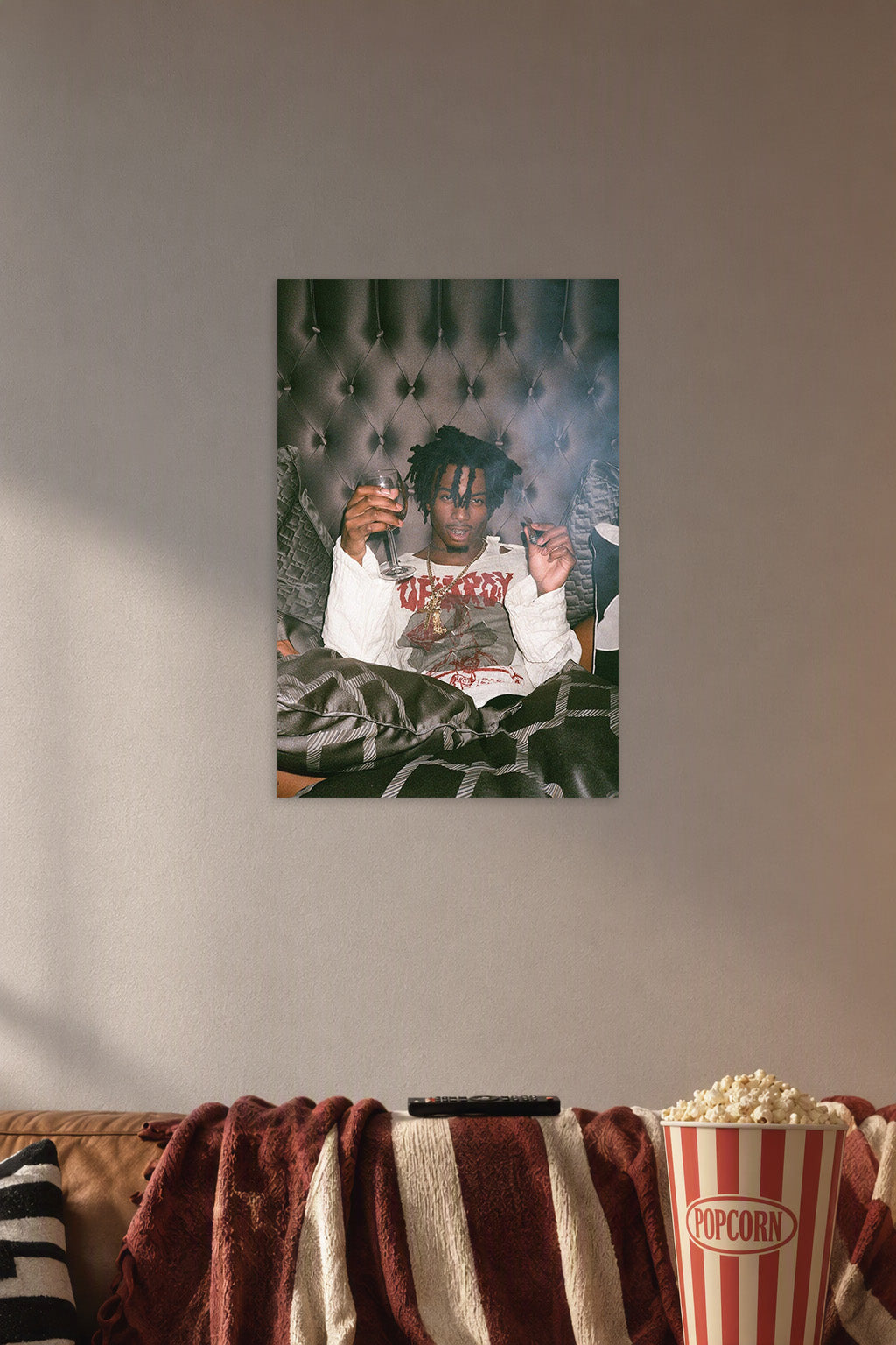 Playboi Carti Poster Musician Concert Tour Rapper in a cozy movie room above a brown sofa with popcorn.