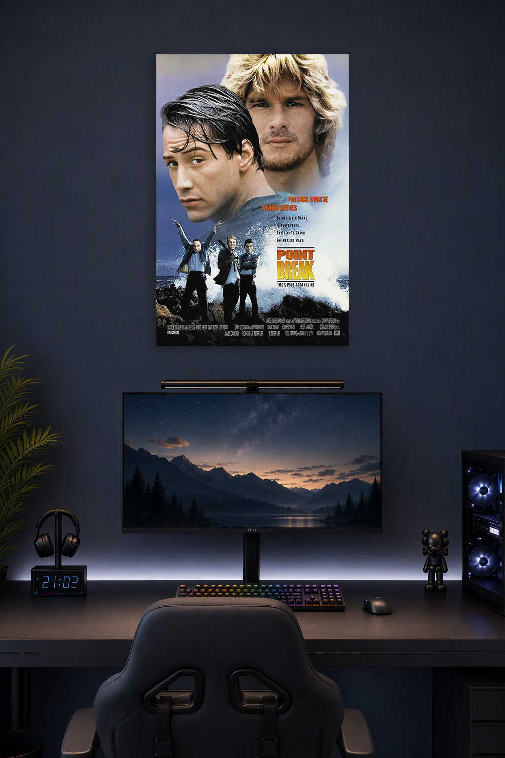 Point Break Movie Poster in a gaming desk setup above a monitor.