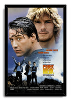 Point Break framed wall art print features Keanu Reeves and Patrick Swayze, masked robbers on rocks, and crashing blue waves.