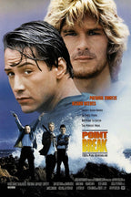 Point Break movie poster features Keanu Reeves and Patrick Swayze above masked robbers, crashing waves, and bold orange title text.