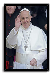Pope Francis framed wall art print depicts the pontiff smiling and waving in white ceremonial attire, bordered by a sleek black frame.