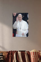 Pope Francis in a cozy movie room above a brown sofa with popcorn.