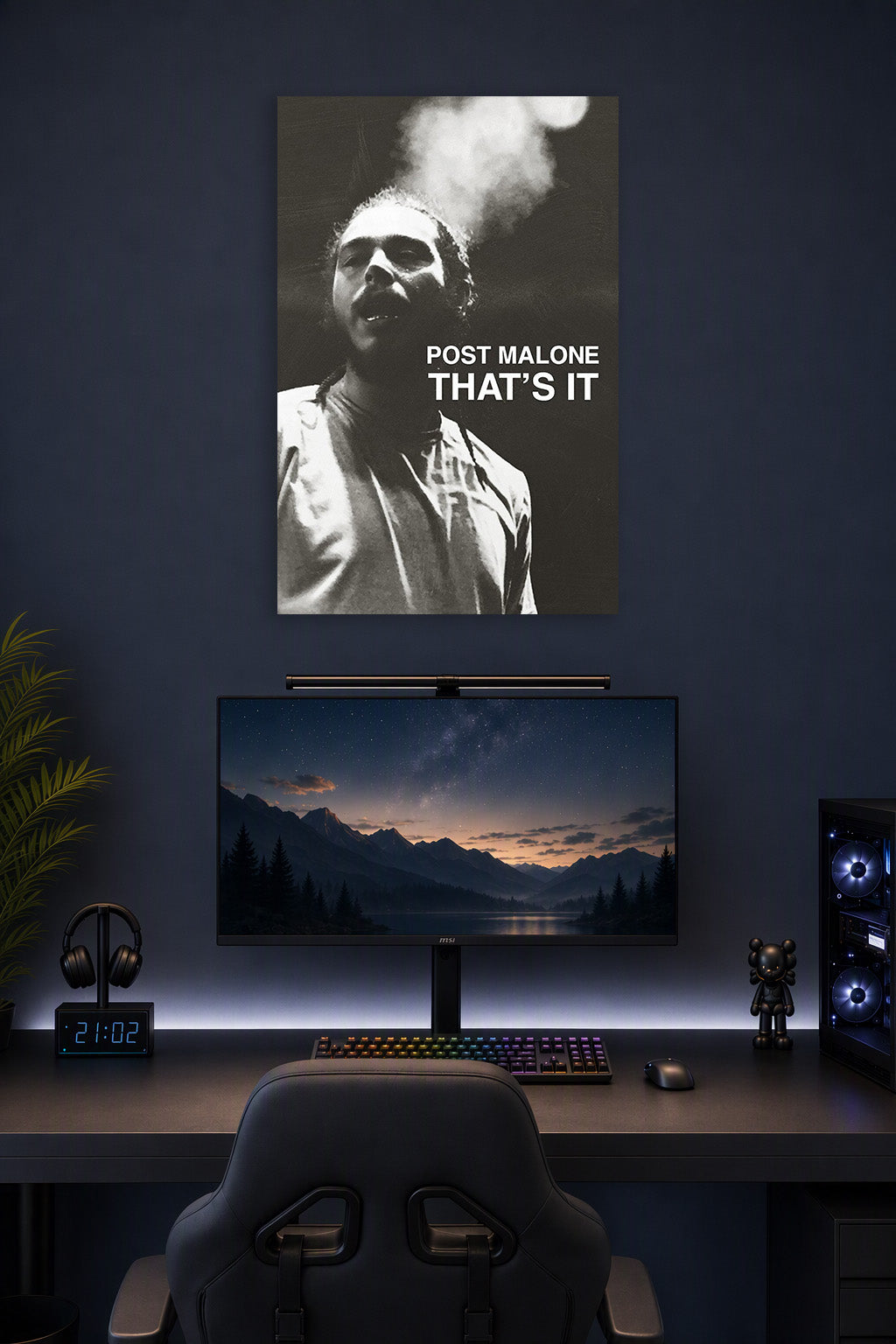 Post Malone in a gaming desk setup above a monitor.